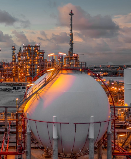 Industrial storage tank and refinery facility at twilight