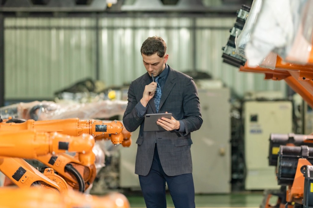 Industrial manager reviewing operations in a modern facility